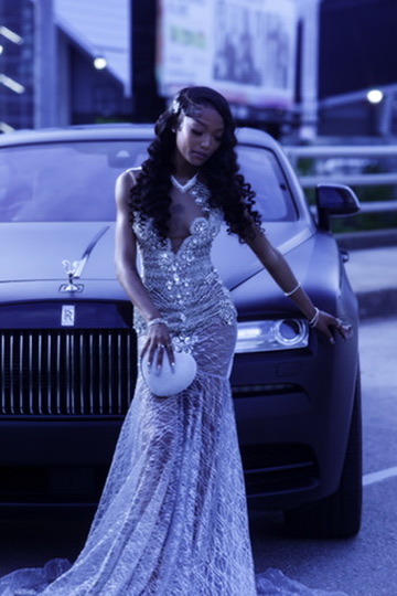 Glam editorial portrait beside a luxury vehicle